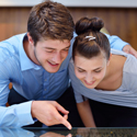 A couple looking at a tablet together