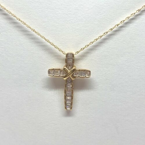 Gold cross necklace with diamonds and a twisted gold center on a chain.