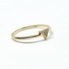 Minimalist gold ring with diamond arrowhead.