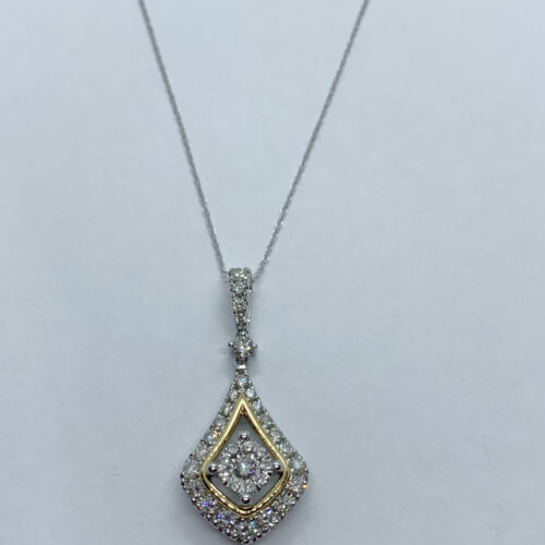 A close-up photo of a white and yellow gold diamond pendant on a chain.