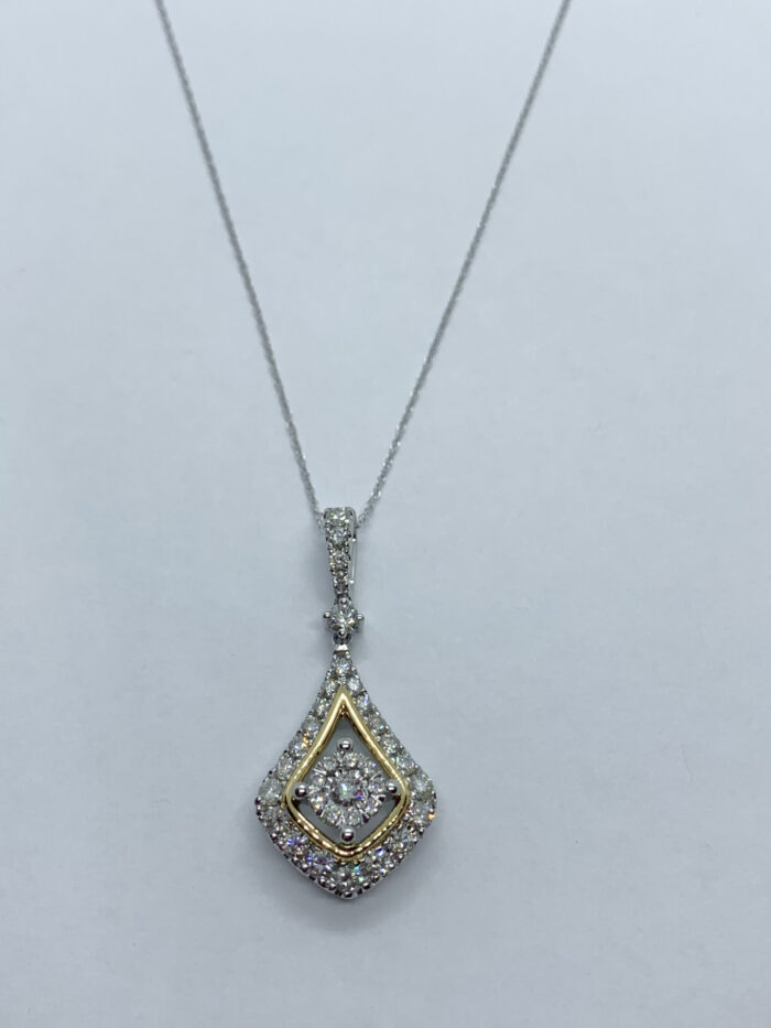 A close-up photo of a white and yellow gold diamond pendant on a chain.