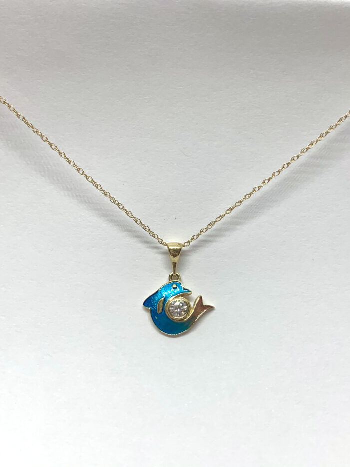 Gold necklace with blue and white dolphin pendant