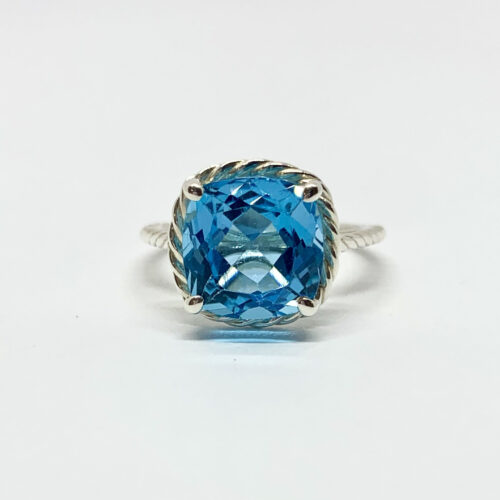 Silver ring with sparkling blue stone