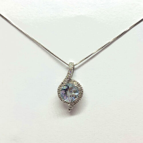 Teardrop-shaped gemstone pendant with a diamond accent on a silver necklace.